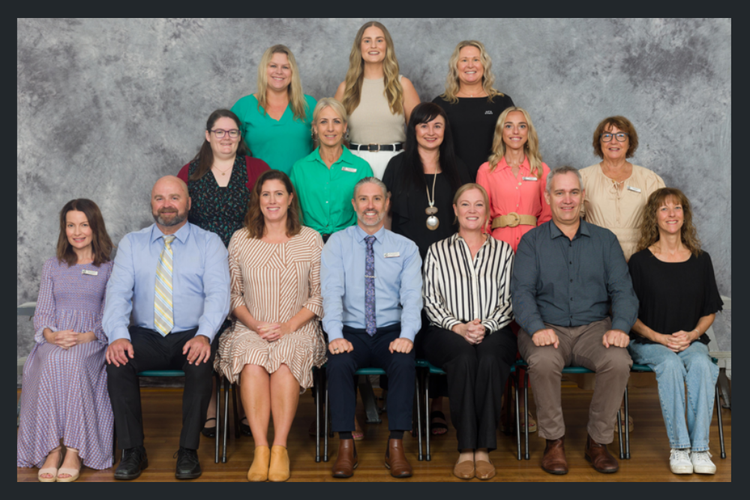 The Dudley Public School staff all pose for a school photo together.