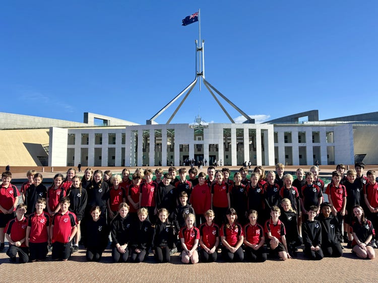 All of Stage 3 pose for a photo in front of the Australian Parliament House.